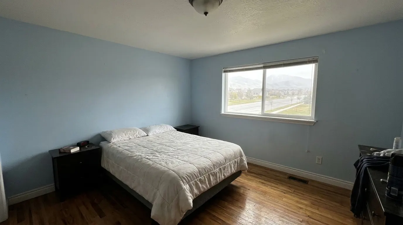 Same bedroom with rebuilt ceiling after storm damage restoration